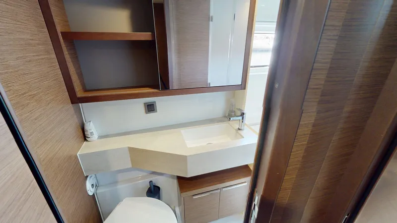 Sliver Fern Yacht Photos Pics Modern bathroom interior on a 2020 Lagoon 46 yacht, featuring sleek wood finishes and a compact design.