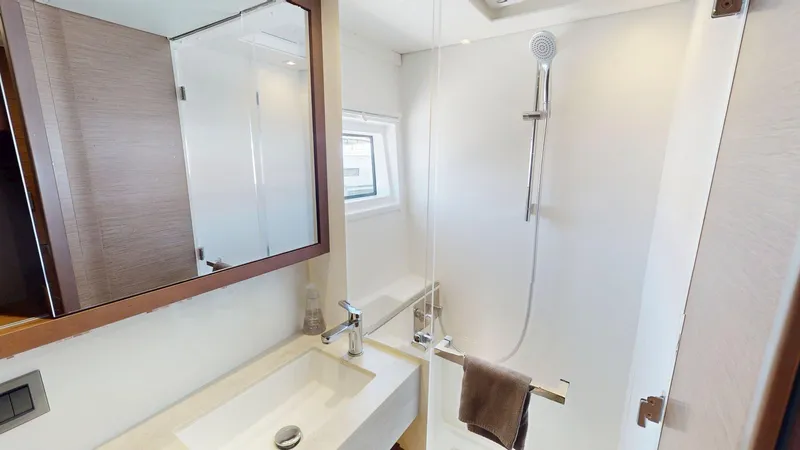 Sliver Fern Yacht Photos Pics Modern bathroom interior on a 2020 Lagoon 46 yacht, featuring a sleek shower and sink.