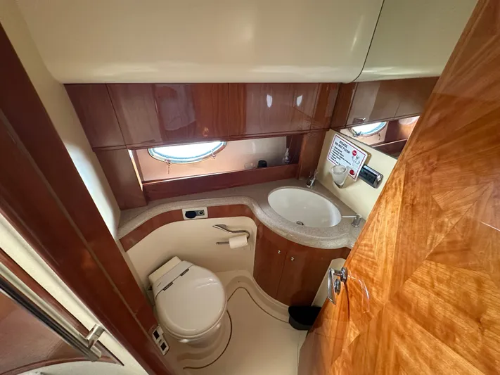  Yacht Photos Pics Luxurious bathroom in 2003 Aicon 56 Flybridge yacht with wood accents and modern fixtures.