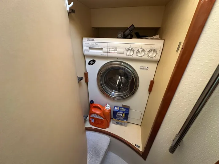  Yacht Photos Pics Laundry area with washer and cleaning supplies on Aicon 56 Flybridge yacht, 2003 model.