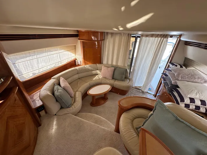  Yacht Photos Pics Luxurious interior of 2003 Aicon 56 Flybridge yacht with plush seating and elegant decor.
