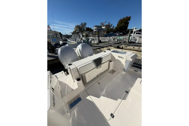  Yacht Photos Pics 2025 Robalo R300 Center Console boat docked, featuring dual outboard engines.