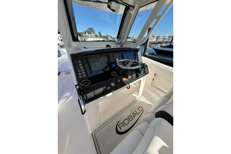  Yacht Photos Pics 2025 Robalo R300 Center Console boat interior with modern dashboard and steering wheel.