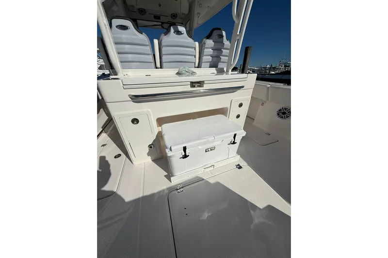  Yacht Photos Pics 2025 Robalo R300 Center Console boat interior with seating and Yeti cooler.