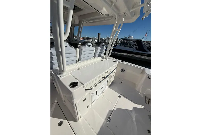  Yacht Photos Pics 2025 Robalo R300 Center Console boat interior with seating and storage, docked at marina.
