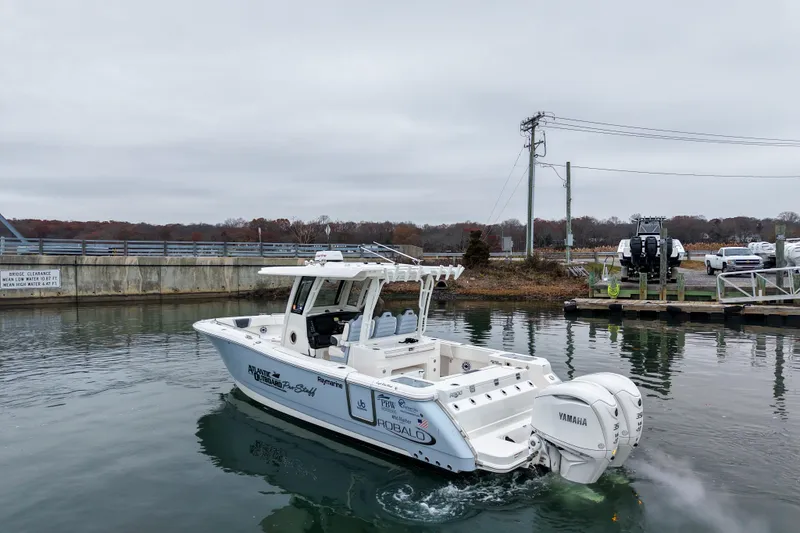  Yacht Photos Pics 2025 Robalo R300 Center Console boat with Yamaha engines on a calm waterway.