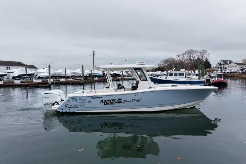  Yacht Photos Pics 2025 Robalo R300 Center Console boat docked in a marina.