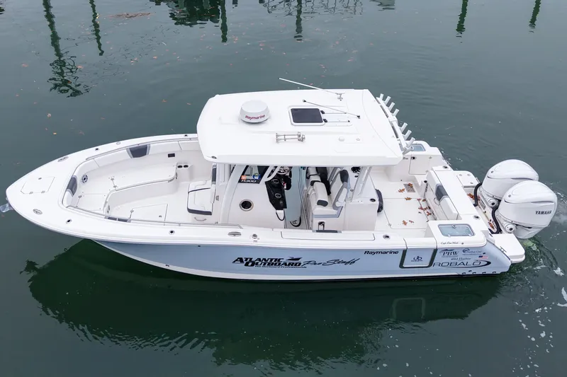  Yacht Photos Pics 2025 Robalo R300 Center Console boat with twin Yamaha engines on calm water.