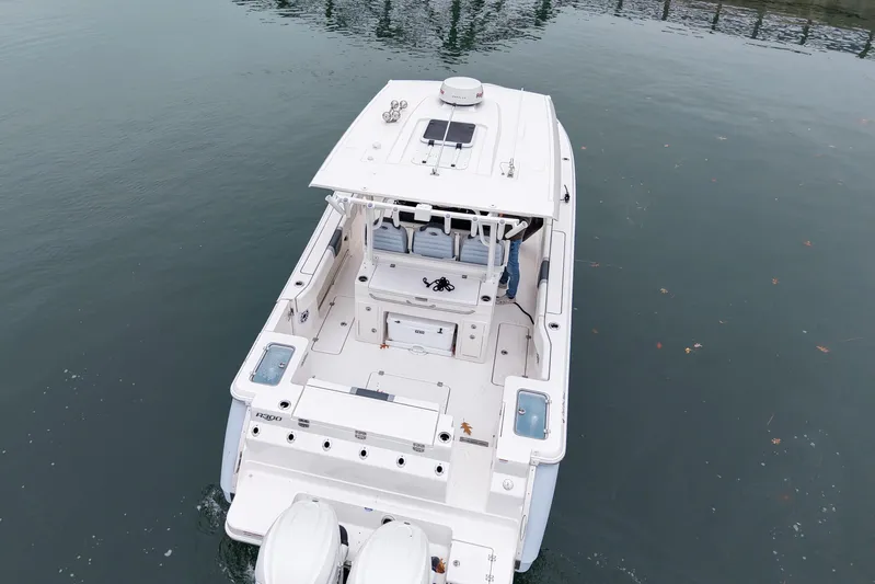  Yacht Photos Pics 2025 Robalo R300 Center Console boat on calm water, aerial view.