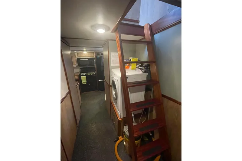  Yacht Photos Pics Interior of 1973 Custom 58&rsquo; Steel Marco Seiner with wooden stairs and laundry area.