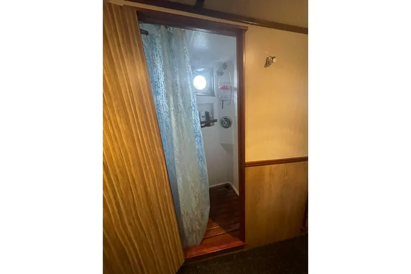  Yacht Photos Pics Interior view of 1973 Custom 58&rsquo; Steel Marco Seiner, featuring a wooden doorway and curtain.