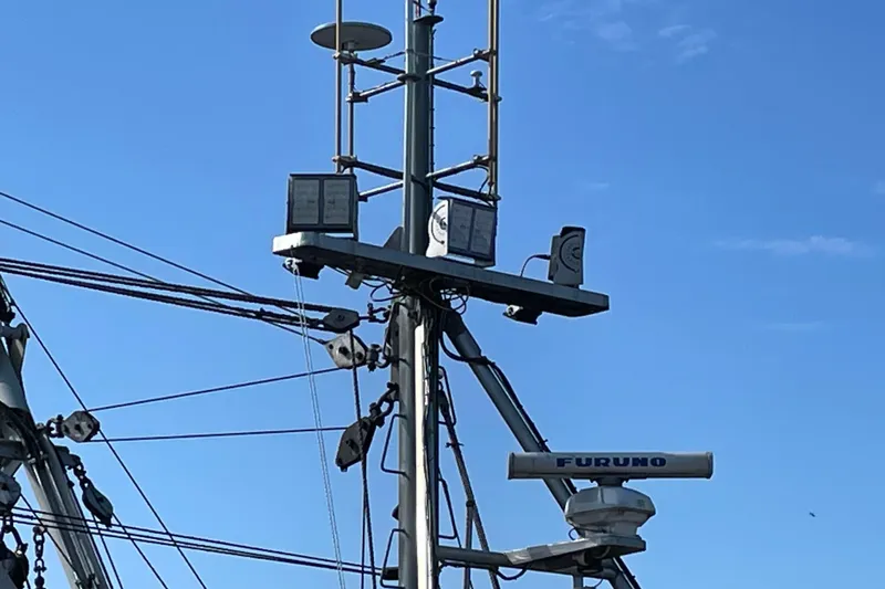  Yacht Photos Pics Radar and communication equipment on 1973 Custom 58&rsquo; Steel Marco Seiner against blue sky.