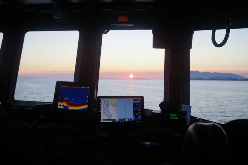  Yacht Photos Pics Interior view of 1973 Custom 58&rsquo; Steel Marco Seiner, sunset over ocean horizon.