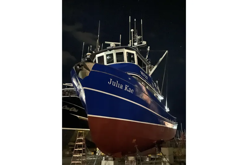  Yacht Photos Pics Blue and red 1973 Custom 58&rsquo; Steel Marco Seiner boat named "Julia Kae" at night.