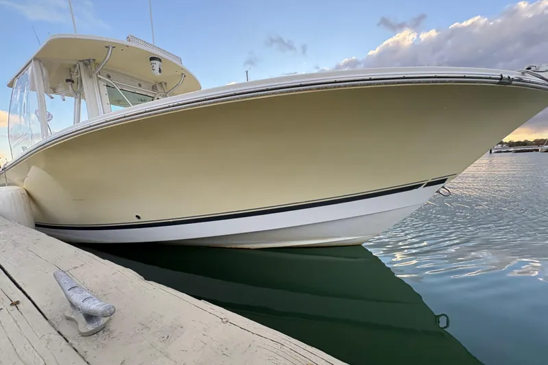 Plan B Yacht Photos Pics 2006 Regulator 32 Forward Seating boat docked on calm water at sunset.