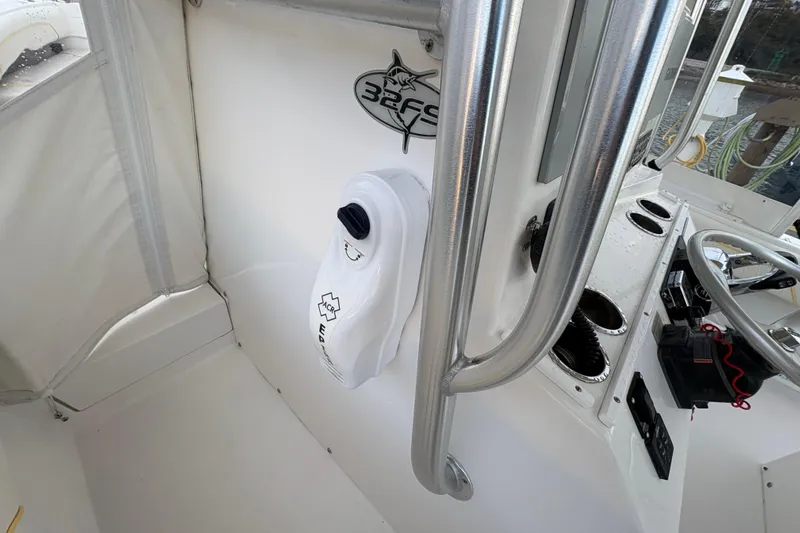 Plan B Yacht Photos Pics 2006 Regulator 32 Forward Seating boat interior with steering wheel and control panel.