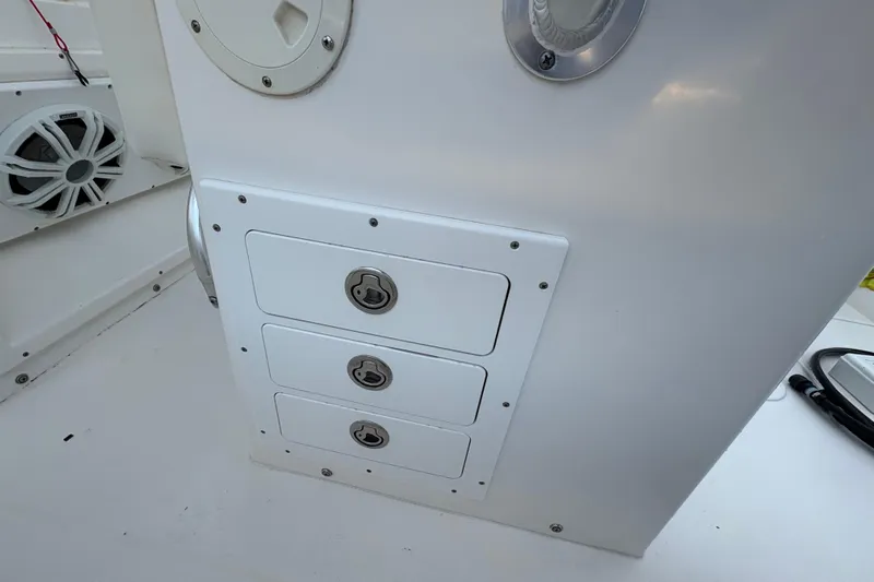 Plan B Yacht Photos Pics 2006 Regulator 32 Forward Seating boat storage compartments with secure locks and speaker system.