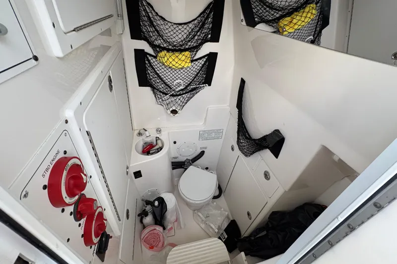 Plan B Yacht Photos Pics Interior of a 2006 Regulator 32 Forward Seating boat, featuring storage and a compact toilet.