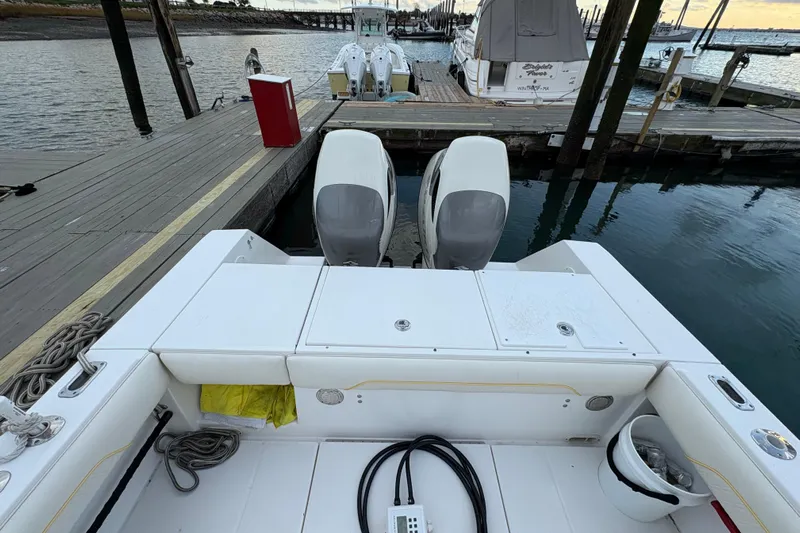 Plan B Yacht Photos Pics 2006 Regulator 32 Forward Seating boat docked with twin engines, rear view.