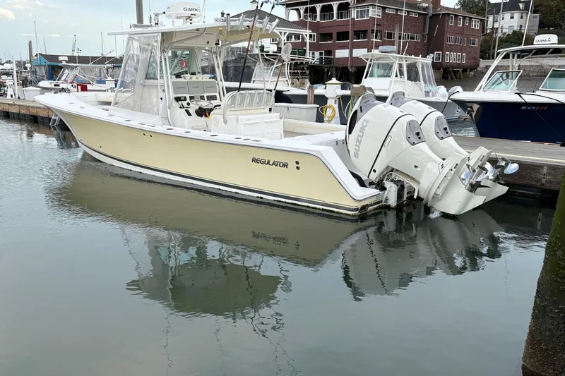 Plan B Yacht Photos Pics 2006 Regulator 32 Forward Seating boat docked in marina with twin Suzuki engines.