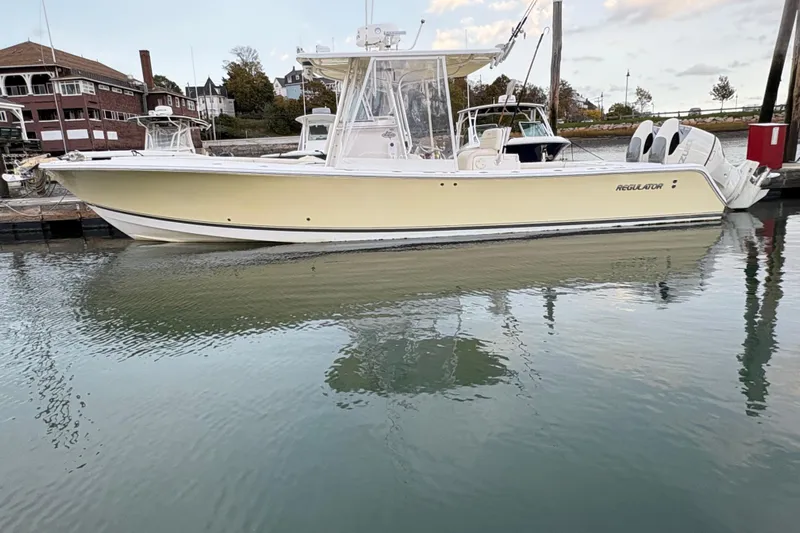 Plan B Yacht Photos Pics 2006 Regulator 32 Forward Seating boat docked in calm waters.