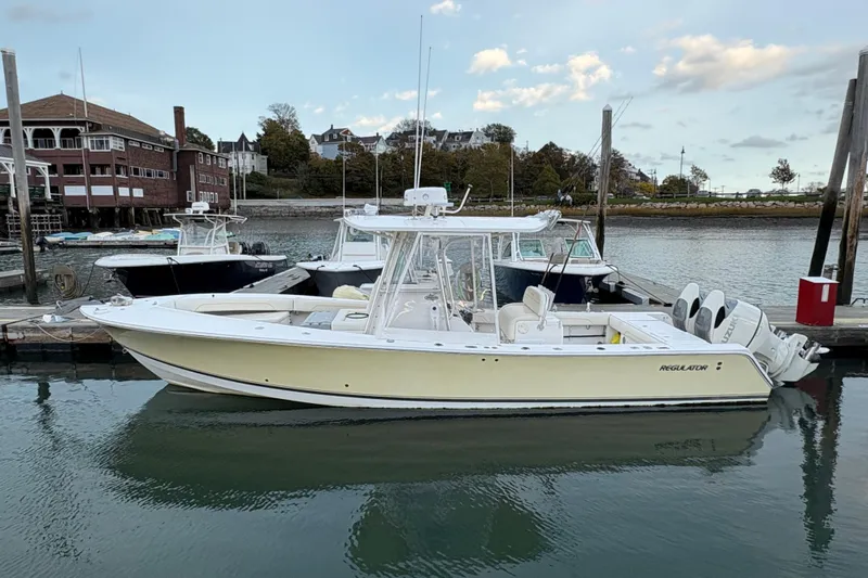 Plan B Yacht Photos Pics 2006 Regulator 32 Forward Seating boat docked in a marina, side view.
