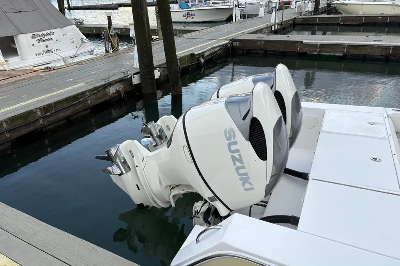 Plan B Yacht Photos Pics 2006 Regulator 32 Forward Seating boat with twin Suzuki outboard motors docked at marina.