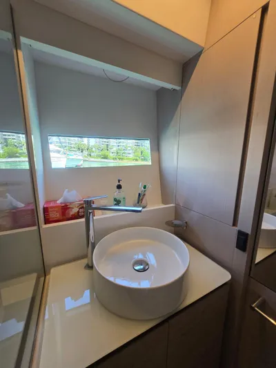 Ferretti Yachts 500 Yacht Photos Pics Modern bathroom on 2022 Ferretti Yachts 500 with sleek sink and window view.