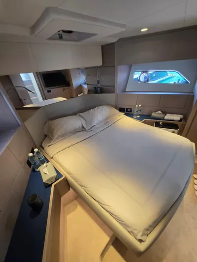 Ferretti Yachts 500 Yacht Photos Pics Luxurious bedroom interior of 2022 Ferretti Yachts 500, featuring a cozy bed and modern amenities.