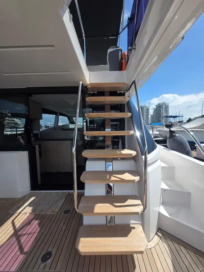 Ferretti Yachts 500 Yacht Photos Pics Staircase on 2022 Ferretti Yachts 500, leading to upper deck, with modern design and wooden steps.