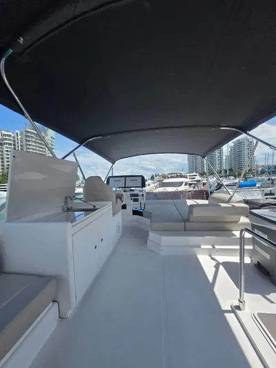 Ferretti Yachts 500 Yacht Photos Pics 2022 Ferretti Yachts 500 flybridge with seating, docked in a marina.