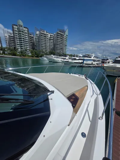 Ferretti Yachts 500 Yacht Photos Pics Ferretti Yachts 500, 2022 model, docked in a marina with modern buildings in the background.