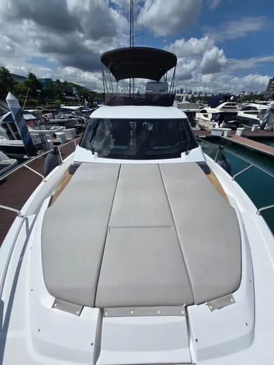 Ferretti Yachts 500 Yacht Photos Pics 2022 Ferretti Yachts 500 docked, showcasing sleek design and spacious deck under cloudy skies.
