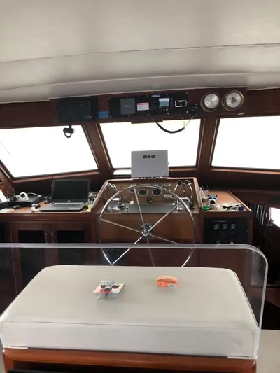  Yacht Photos Pics 1980 Hatteras 53 Motor Yacht helm with steering wheel, navigation equipment, and control panel.