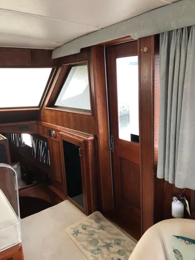  Yacht Photos Pics Interior of 1980 Hatteras 53 Motor Yacht with wood paneling and nautical decor.