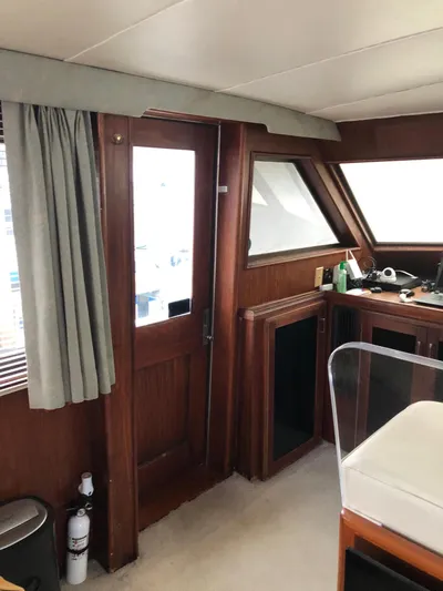  Yacht Photos Pics Interior of 1980 Hatteras 53 Motor Yacht with wood paneling and nautical decor.