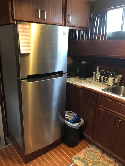  Yacht Photos Pics Kitchen area of 1980 Hatteras 53 Motor Yacht with stainless steel refrigerator.