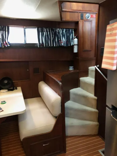 Yacht Photos Pics Interior of 1980 Hatteras 53 Motor Yacht with wooden paneling and cozy seating area.