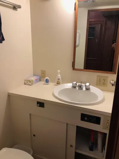  Yacht Photos Pics Bathroom vanity on 1980 Hatteras 53 Motor Yacht with sink, mirror, and toiletries.