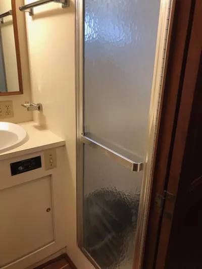  Yacht Photos Pics Bathroom interior of 1980 Hatteras 53 Motor Yacht with shower and sink.