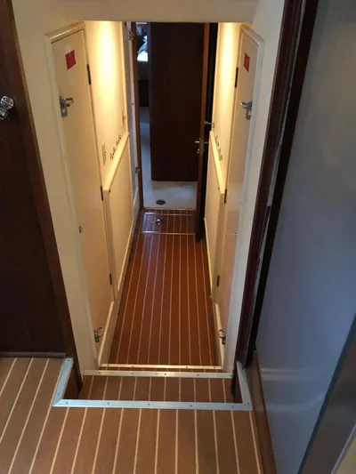 Yacht Photos Pics Interior hallway of 1980 Hatteras 53 Motor Yacht with wood flooring and doors.