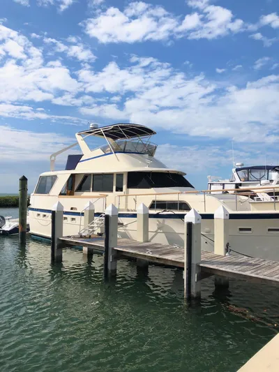  Yacht Photos Pics 1980 Hatteras 53 Motor Yacht docked under a blue sky.
