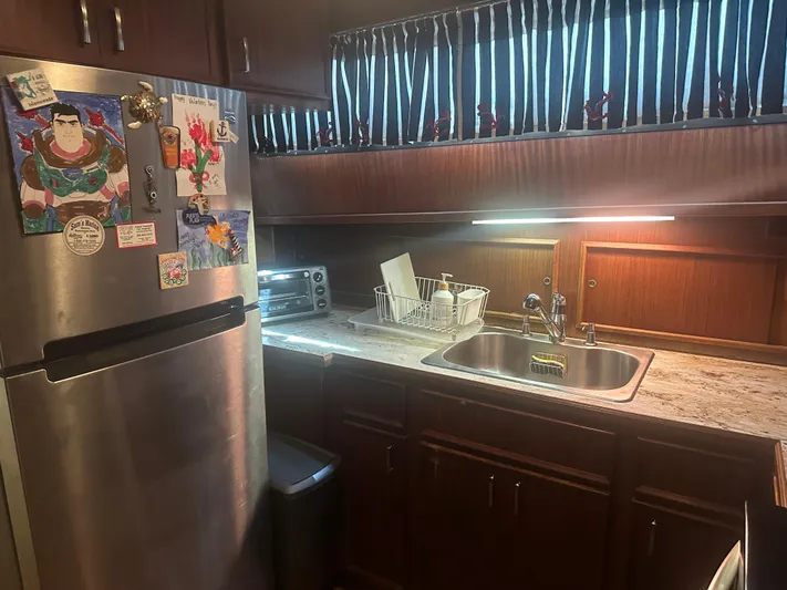  Yacht Photos Pics Kitchen area of a 1980 Hatteras 53 Motoryacht with stainless steel appliances.