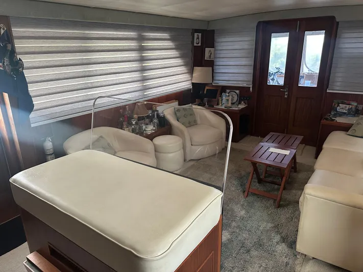  Yacht Photos Pics Luxurious interior of a 1980 Hatteras 53 Motoryacht with plush seating and elegant decor.