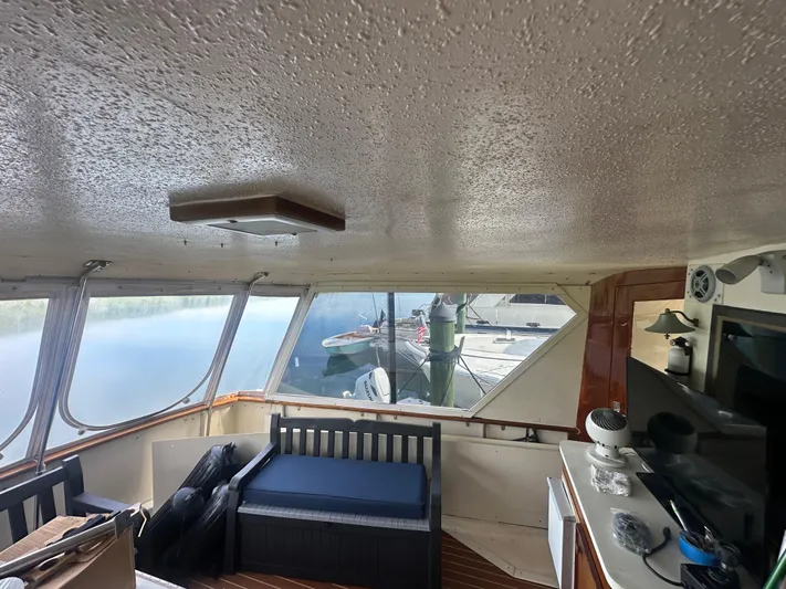 Yacht Photos Pics Interior of 1980 Hatteras 53 Motoryacht with seating and view of marina.