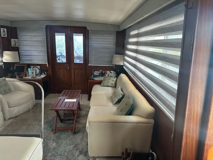  Yacht Photos Pics Interior of 1980 Hatteras 53 Motoryacht with cozy seating and wooden accents.