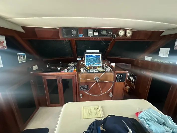  Yacht Photos Pics Interior helm of 1980 Hatteras 53 Motoryacht with steering wheel and navigation equipment.