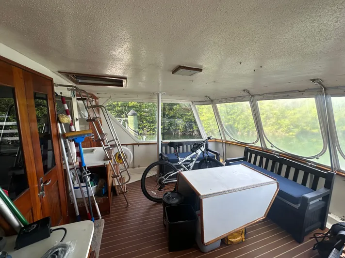  Yacht Photos Pics Interior of 1980 Hatteras 53 Motoryacht with seating, table, and bicycle.