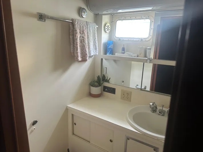  Yacht Photos Pics Bathroom interior of 1980 Hatteras 53 Motoryacht with sink, mirror, and towel rack.