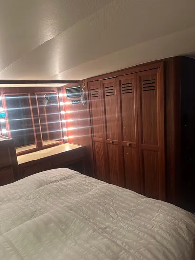  Yacht Photos Pics Interior of 1980 Hatteras 53 Motoryacht with wood paneling and cozy bedding.